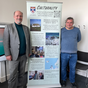 two people standing beside a poster