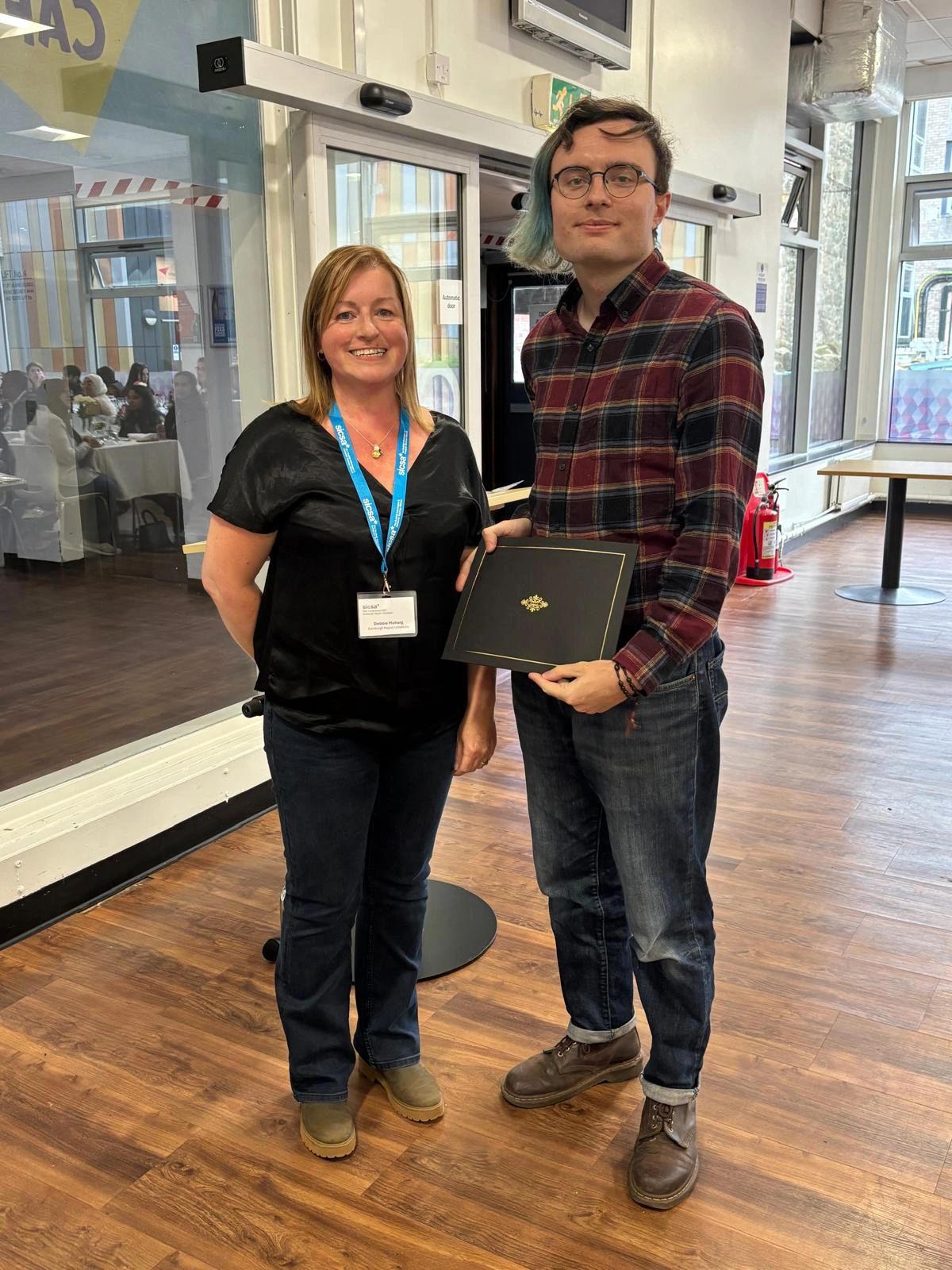 Gregor (Lecturer in the Department of Cybersecurity and Computing at Abertay University, and PhD Award Recipient) is standing next to Debbie Meharg, Head of Applied Informatics at Edinburgh Napier University, Director of Education for SICSA, and the Awards Chair for the SICSA PhD Conference 2025